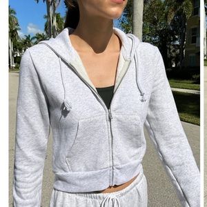Brandy Melville cropped zip hoodie in light pink. One size.